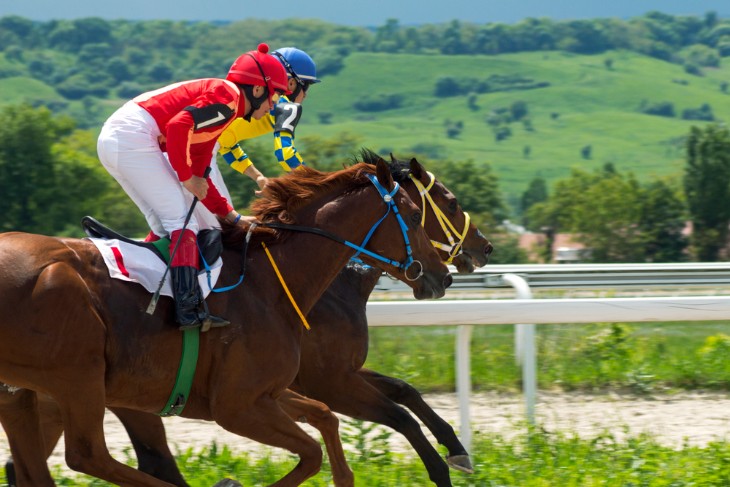 A jockey trains with  her horse